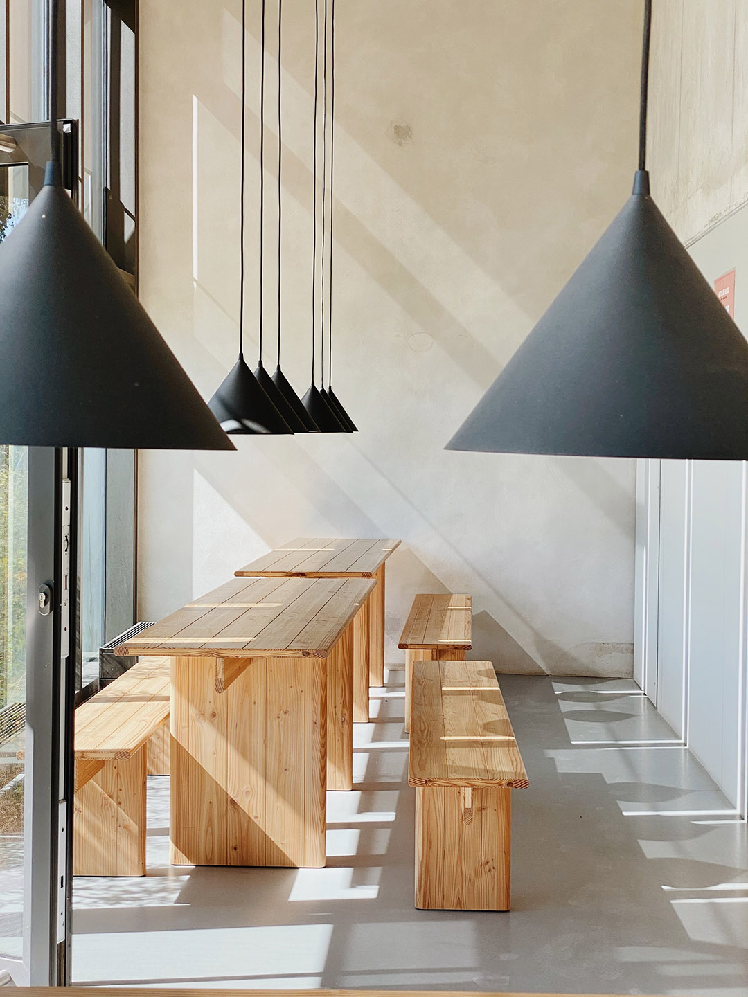 Basil Lab - Interior shot - bench seating with low hanging lamps.